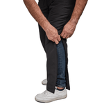 Primo piano di mani che aprono pantaloni termici Dobsom lateralmente sopra i jeans